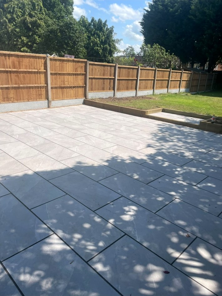 Large paved patio and timber fencing